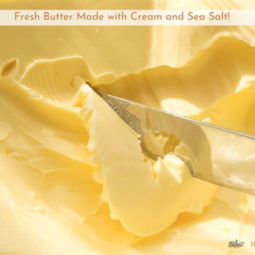 homemade butter in a dish being cut with a knife.