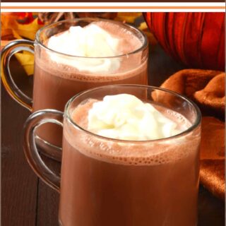 pumpkin hot chocolate in two cups on a table