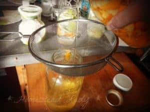 homemade citrus laundry wash vinegar cleaner by www.homesteadlady.com strain out the peels and squish