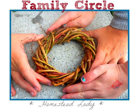 many hands holding the same grape vine wreath