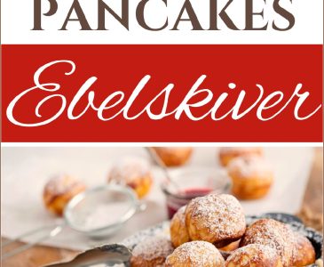 sourdough ebelskiver pancakes on a plate with powdered sugar