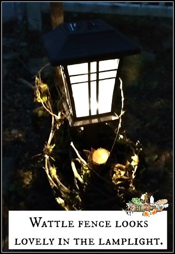 wattle fence holding a pathway light