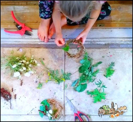 child making herbal grape vine wreaths