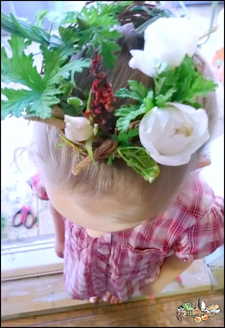 child wearing herbal grape vine wreath crown