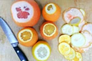 variety of citrus slices and whole citrus with knife