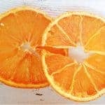A close up of a slice of orange cut in half