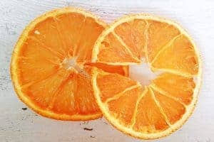 A close up of a slice of orange cut in half