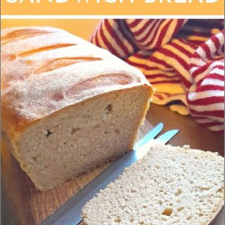 sourdough discard sandwich bread on a cutting board with a knife