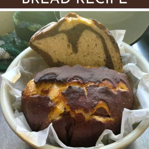 sourdough marble rye loaf in a bowl cut in half