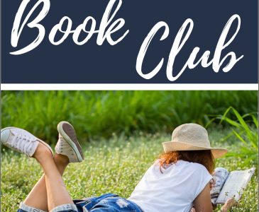 woman reading a book in the grass