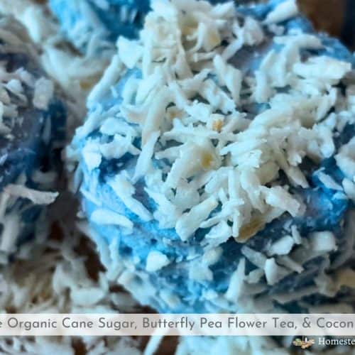 snowball marshmallows with blue plant dye rolled in coconut sitting on a plate