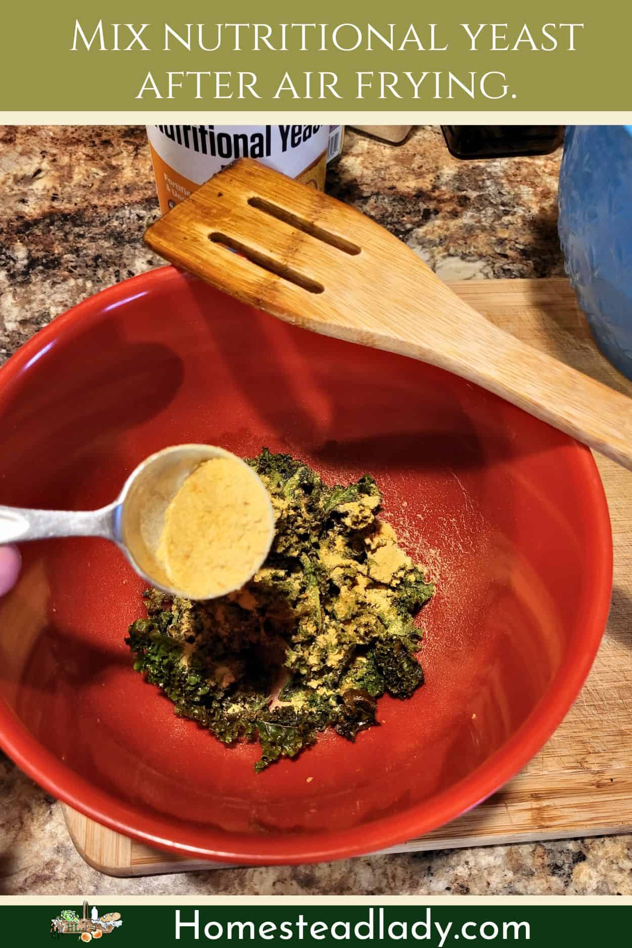 air fryer kale chips being tossed in a tablespoon of nutritional yeast powder