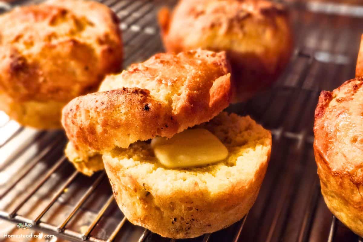 savory sourdough Yorkshire pudding popovers on a bakers rack with butter