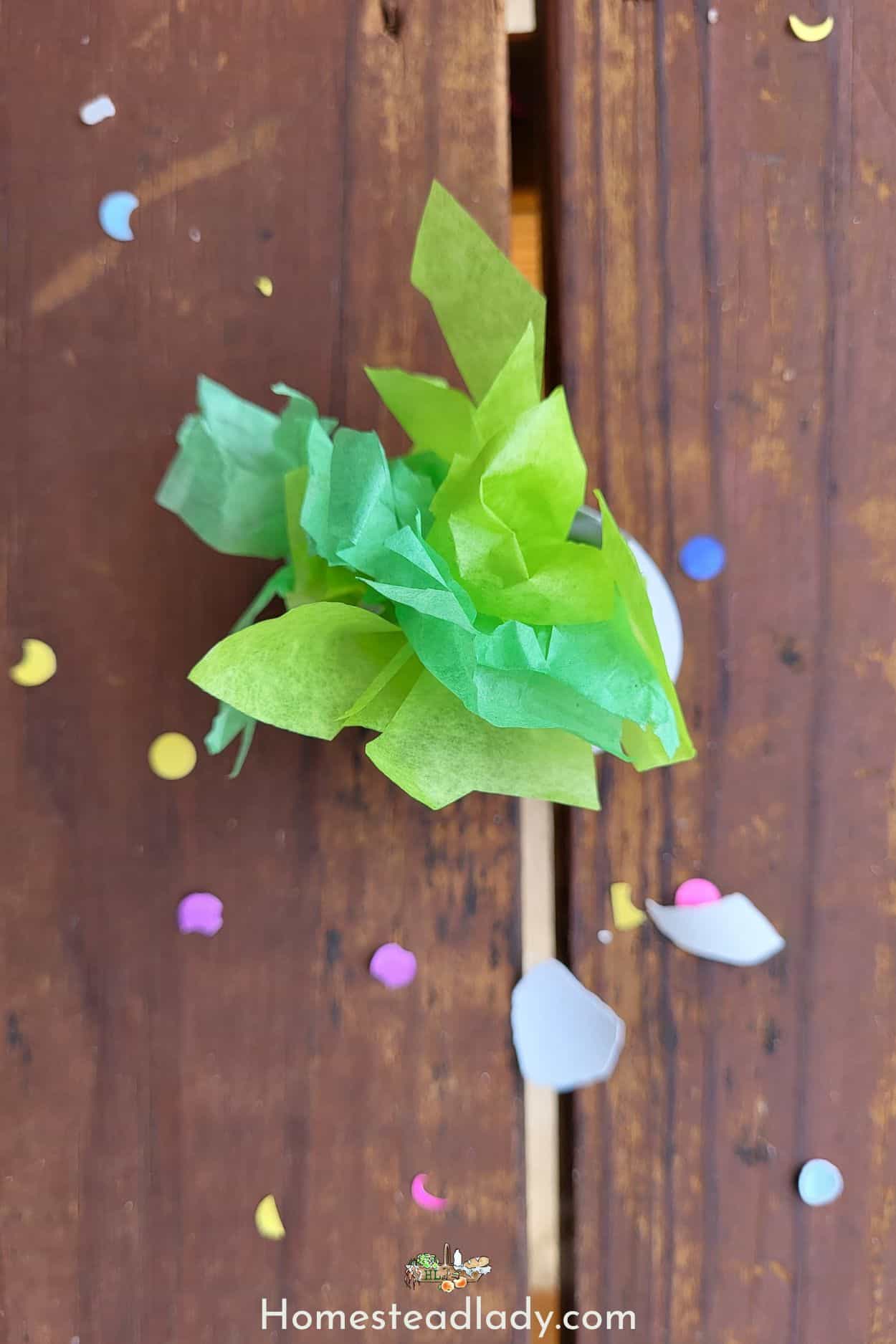 broken and empty homemade confetti egg with confetti all around