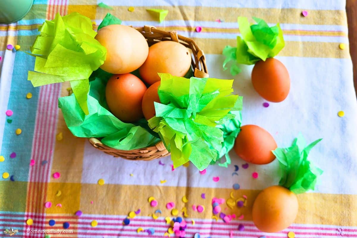 homemade confetti eggs in a basket on a table